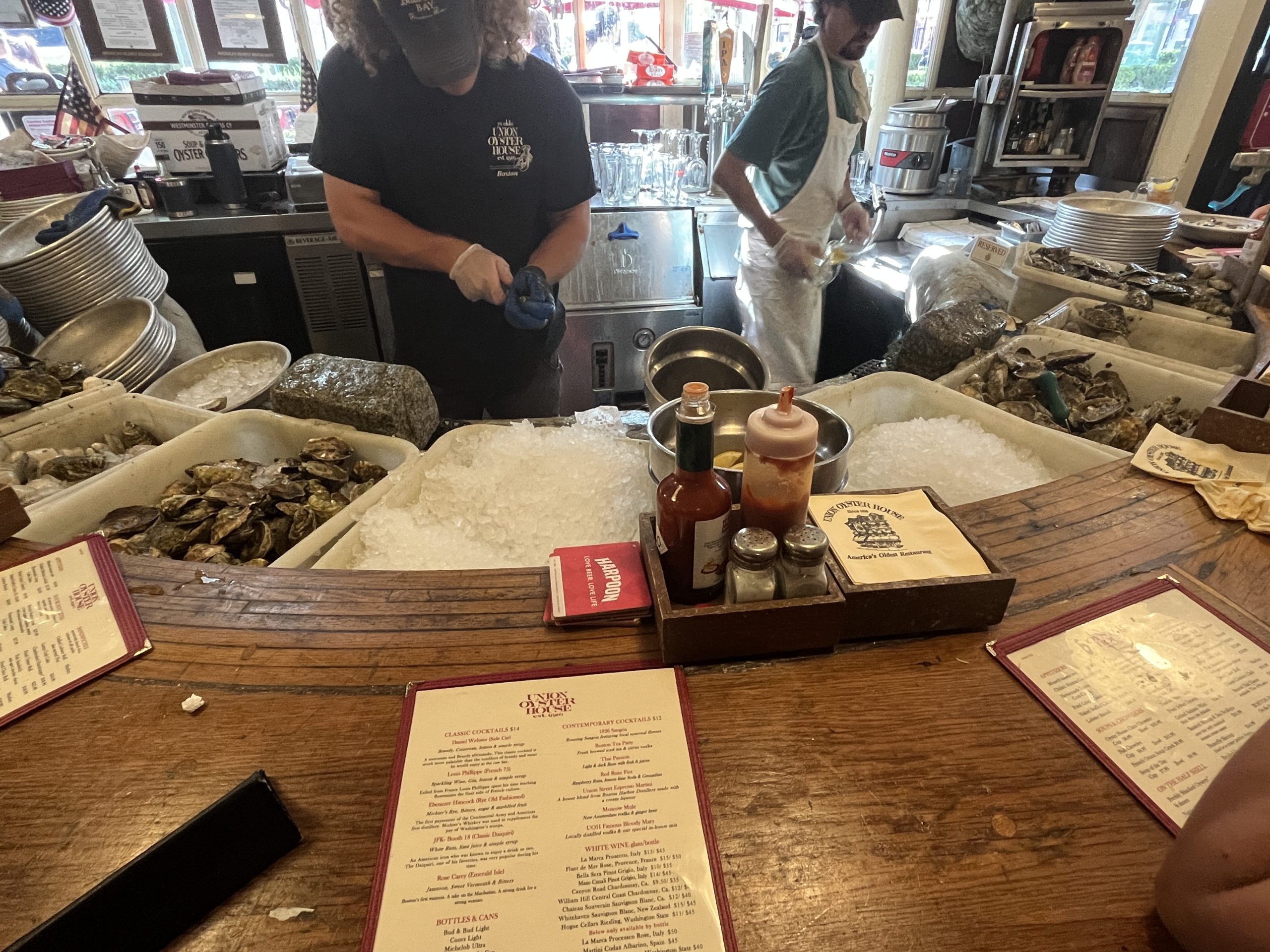 Several bins of oysters at the bar