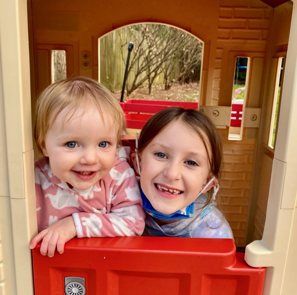 Rosie playing in Mercy's new playhouse